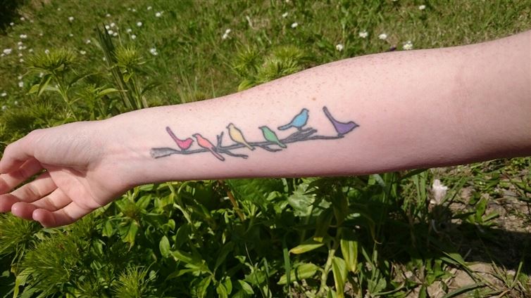 This rainbow colored bird tattoo.