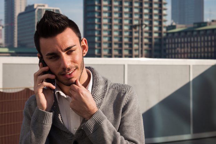 handsome young man talking on phone
