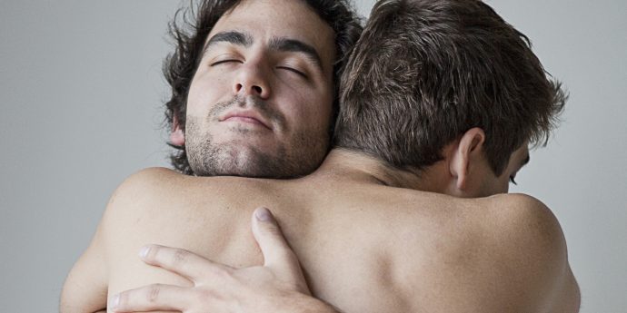 Gay male couple embracing
