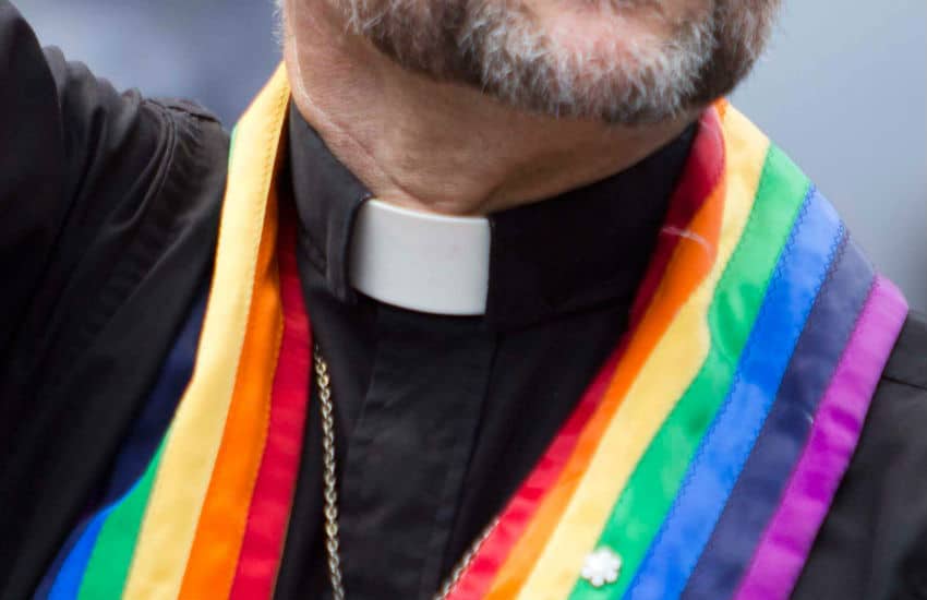 Gay priest with rainbow collar