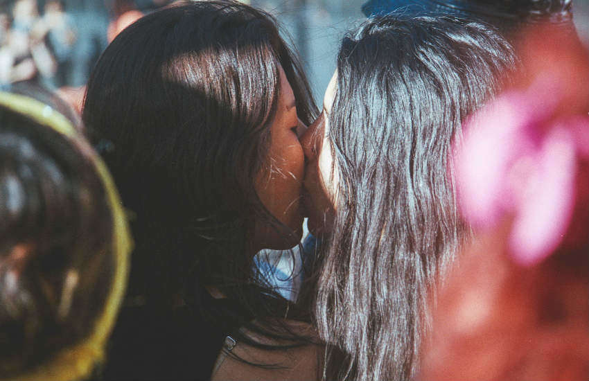 Closeups of two women kissing