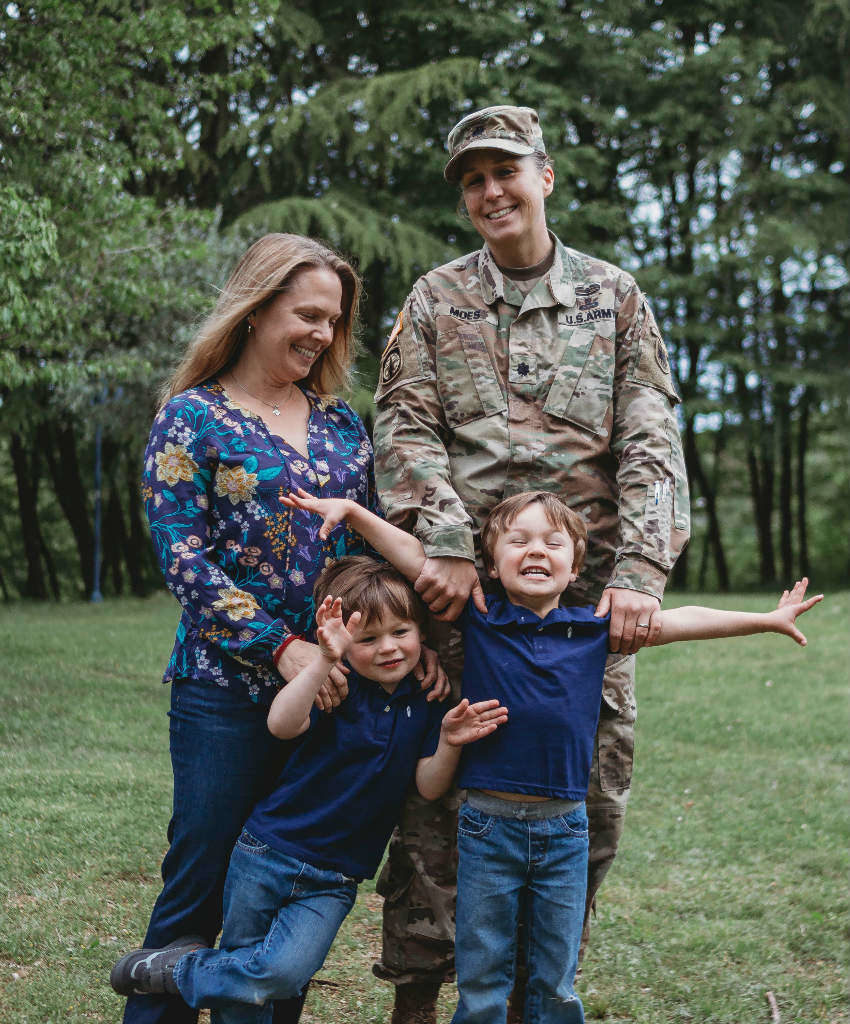 Another shot of Casy Moes, wearing a military uniform, with wife and sons.