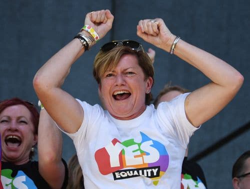 Christine Forster, the sister of former Prime Minister Tony Abbott, celebrates after watching the same sex marriage vote result announcement. (AAP)