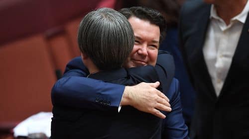 Labor senate leader Penny Wong receives a hug from Liberal senator Dean Smith. (AAP)